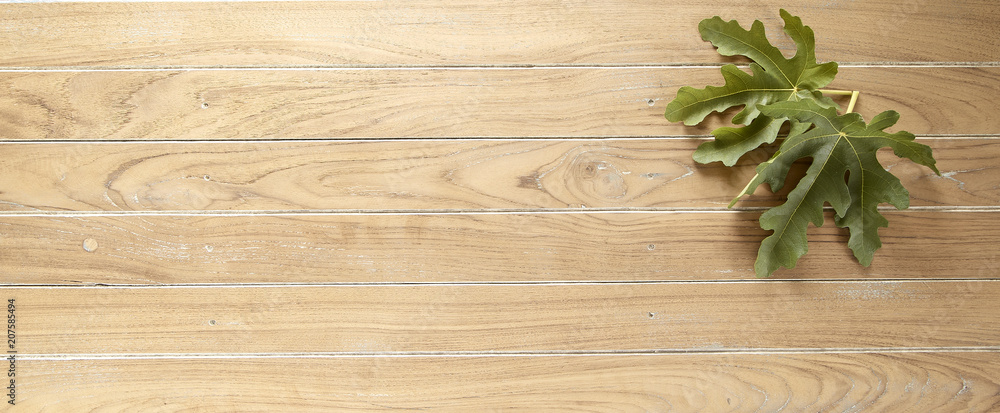 fig leaves on wooden background fig leaves on wooden background
