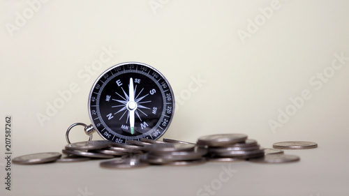 Close-up image of compass and coins.