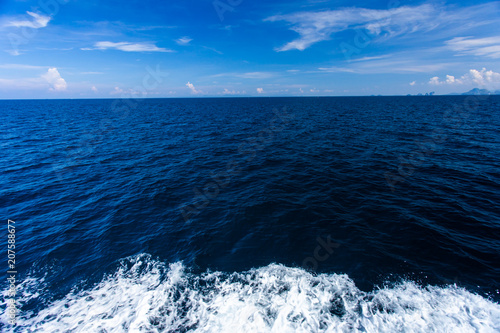 Blue Seawater with sea foam as background