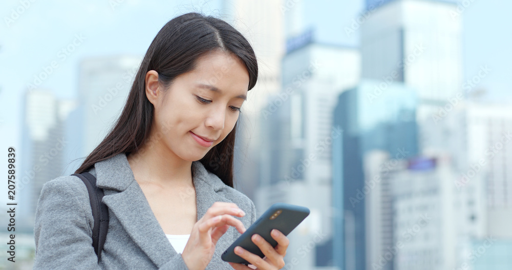 Businesswoman use of smart phone in Hong Kong Businesswoman use of smart phone in Hong Kong