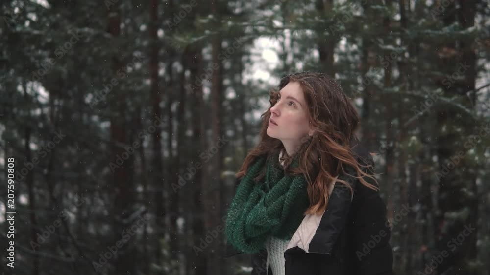 portrait of a red-haired girl walking through a winter forest portrait of a red-haired girl walking through a winter forest