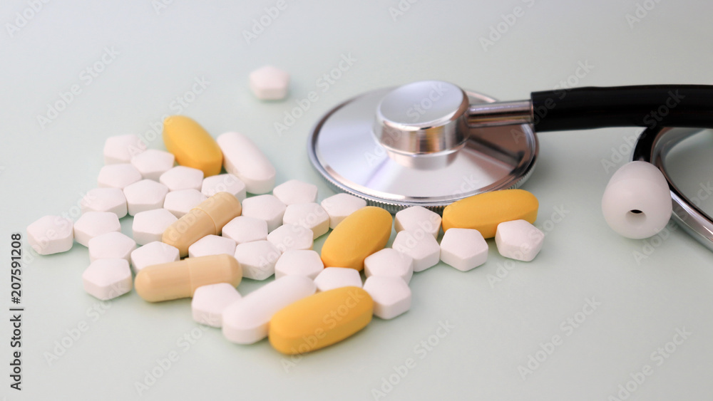 Close-up image of stethoscope and pills. Close-up image of stethoscope and pills.
