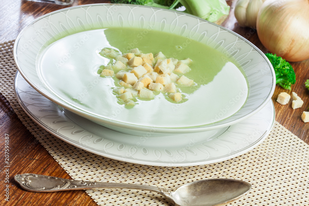 Broccoli cream soup in plate served with croutons Broccoli cream soup in plate served with croutons