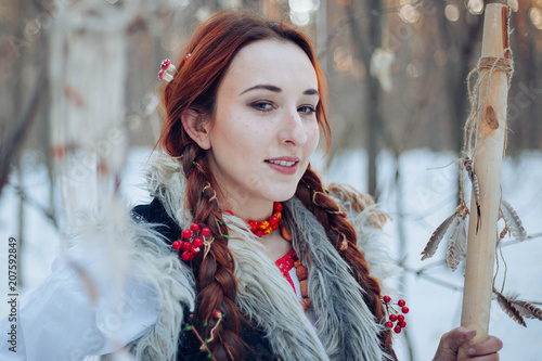  Beautiful girl with long braids in a winter forest. A witch from a fairy tale. fantasy Photo