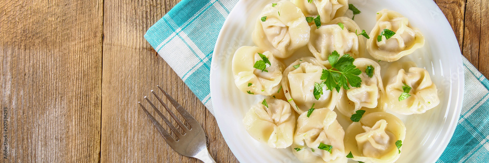 Homemade ready dumplings on an old wooden table. Homemade ready dumplings on an old wooden table.