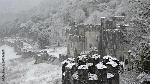 Gwrych castle Ruins in snow, magical British European castle Snowing gently overlooking the castle with turret in foreground