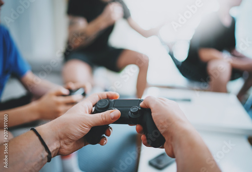 Friendship  technology  games and relaxing time at home concept - close up of male friends playing video games at living room.
