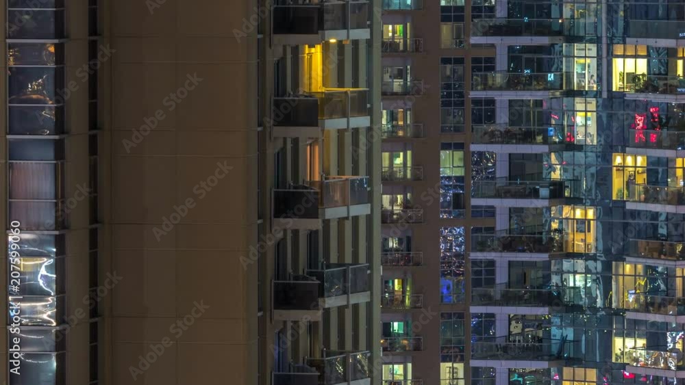 Windows of the multi-storey building of glass and steel lighting inside and moving people within timelapse Windows of the multi-storey building of glass and steel lighting inside and moving people within timelapse
