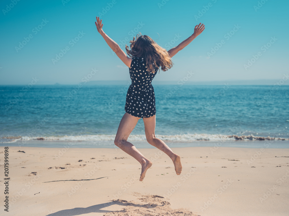 Happy woman jumping on the beach Happy woman jumping on the beach