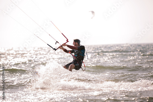 Kitesurfing Kiteboarding action photos man among waves quickly goes © Mediteraneo