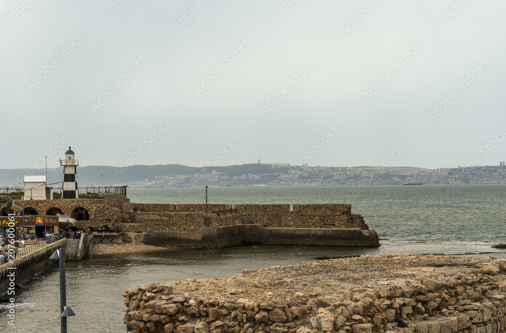 Acre, Israel - May 10, 2018 : Lighthouse on the wall in the port of old Acre Acre, Israel - May 10, 2018 : Lighthouse on the wall in the port of old Acre