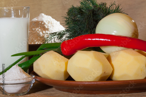 Ingredients for home cooking Ukrainian vareniki: potatoes, onions, salt, kefir, flour, dill photo