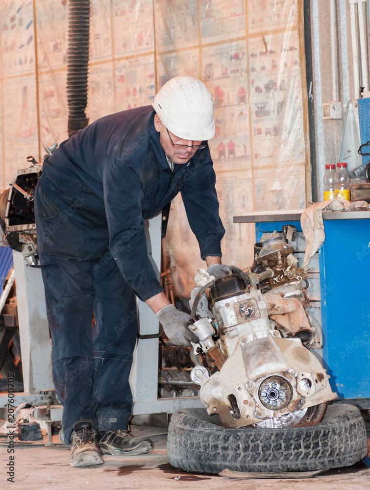 Professional car mechanic working in auto repair service. Professional car mechanic working in auto repair service.