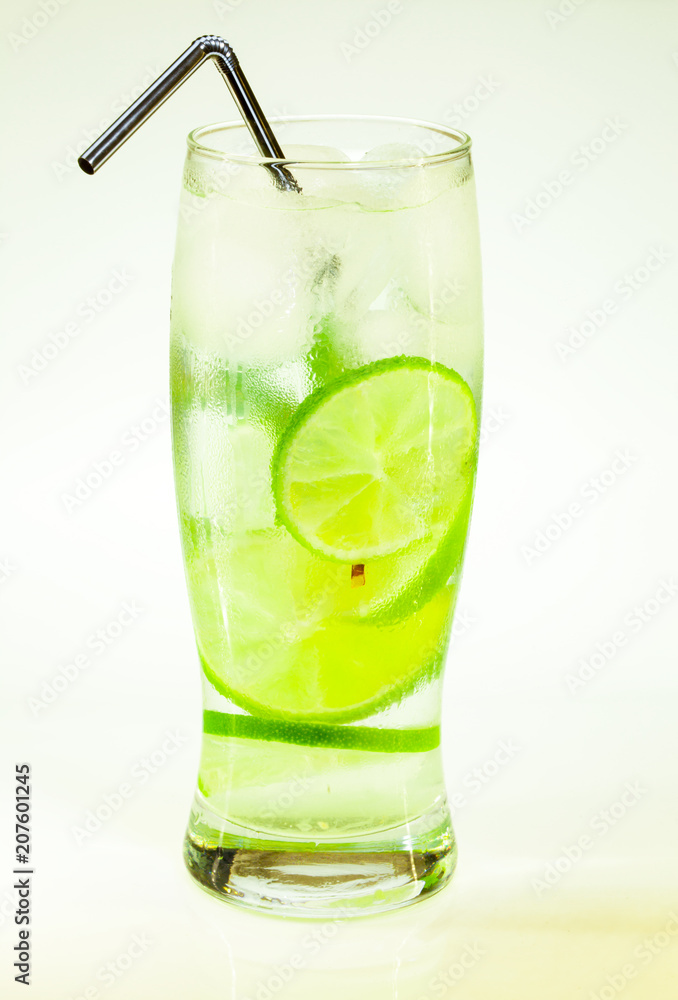 summer cold drink mojito lime and mint with ice and soda with drops on a glass on a white background summer cold drink mojito lime and mint with ice and soda with drops on a glass on a white background