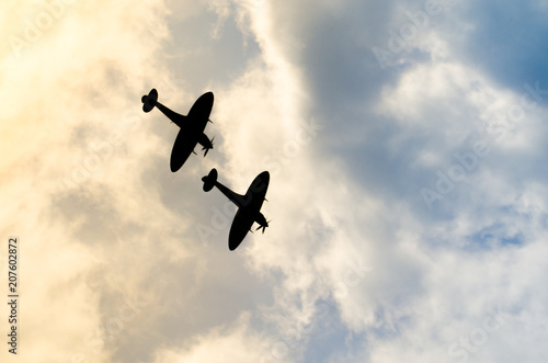 Fotótapéta Two silhouetted spitfires dive out of the bright sun, as if attacking an enemy with surprise