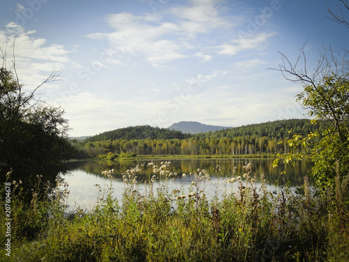 Autumn landscape: a forest lake surrounded by forest