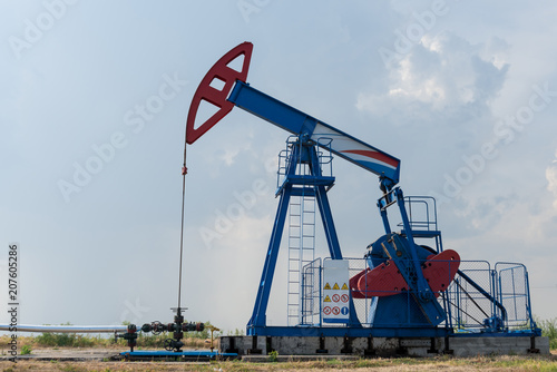 Working oil rig in a cornfield