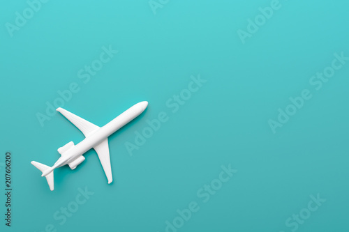 Toy plane on turquoise background