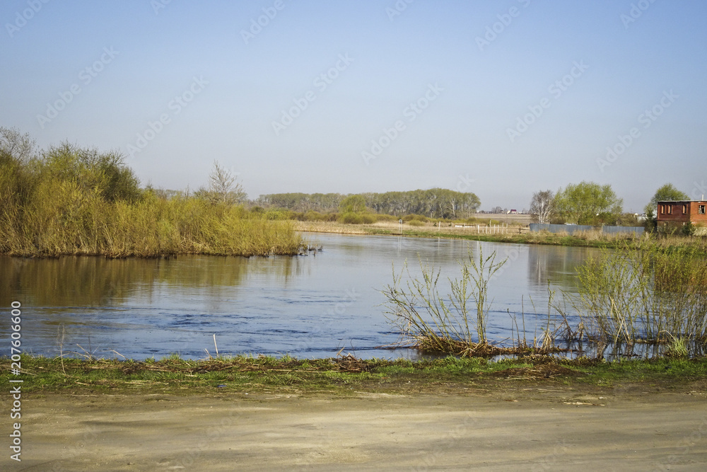 Landscape: calm river in early spring, high water