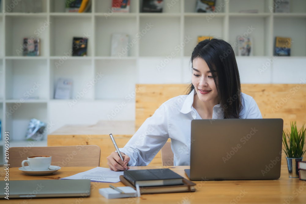 Young woman sitting at cafe working on laptop Young woman sitting at cafe working on laptop