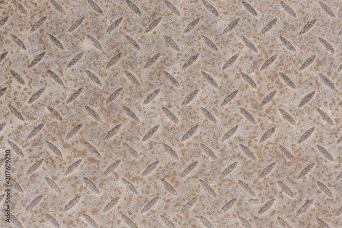 Industrial wallpaper of functional anti-slip metal diamond plate and rough raised surface pattern. Creative background macro photography of construction for catwalks, stairs, walkway.