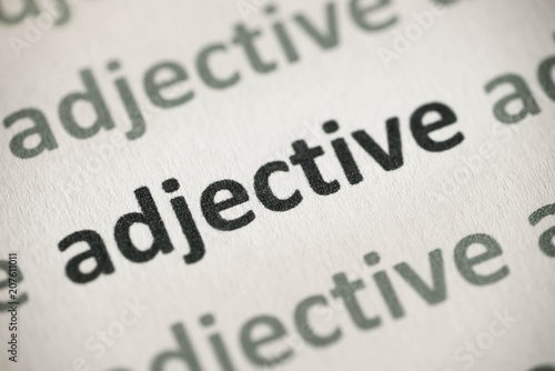 word adjective printed on paper macro photo