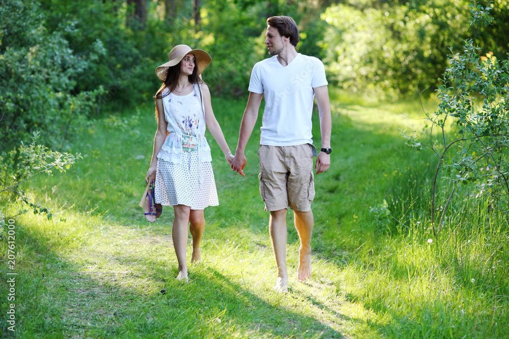 Fototapeta premium Young couple walking in the woods