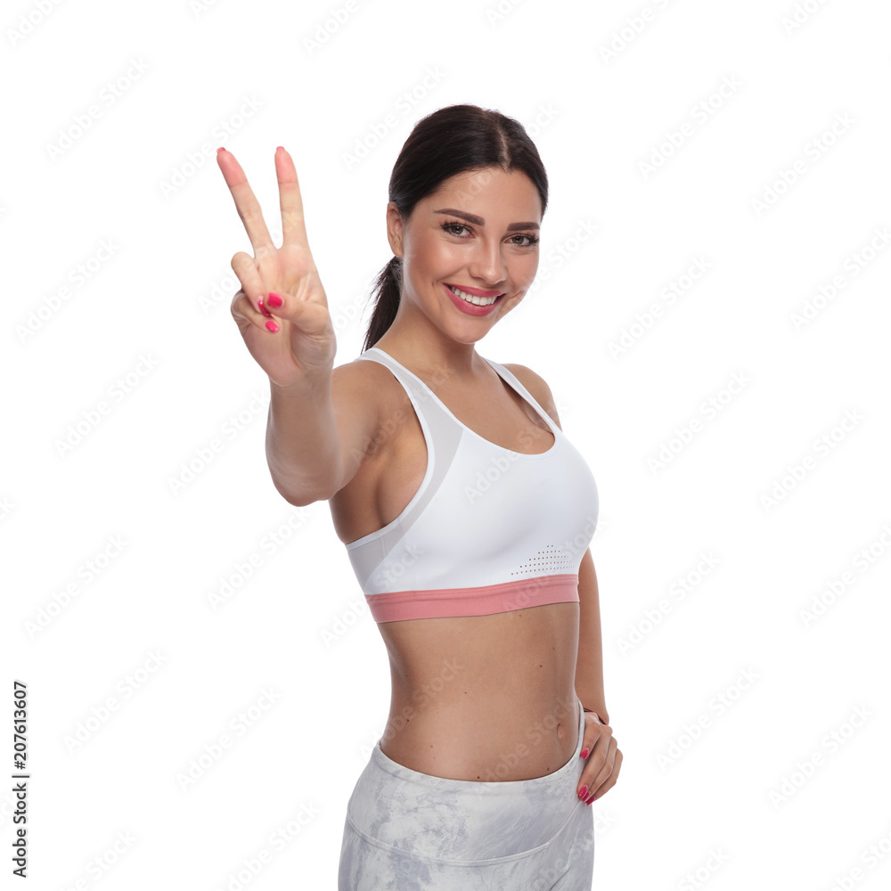 portrait of beautifulfitness woman making victory sign portrait of beautifulfitness woman making victory sign
