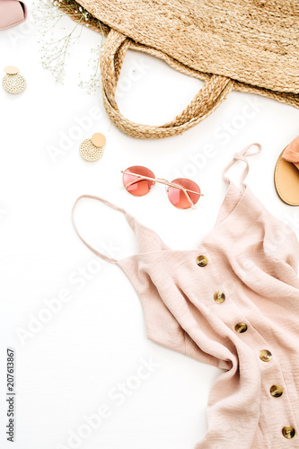 Summer pink feminine clothes and accessories on white background. Flat lay, top view. Summer fashion concept.