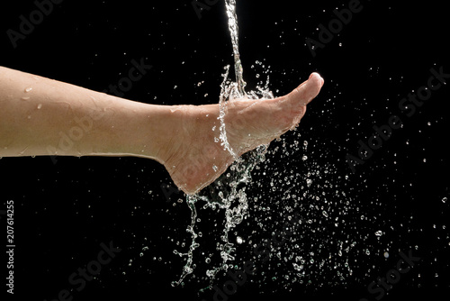 Woman's foots with water splash