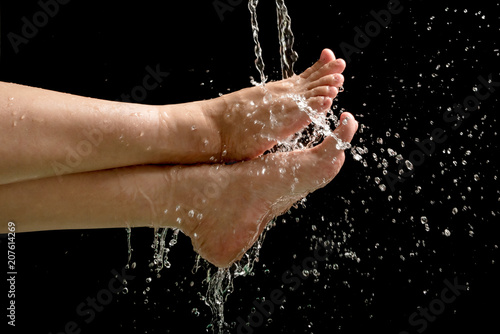 Woman's foots with water splash