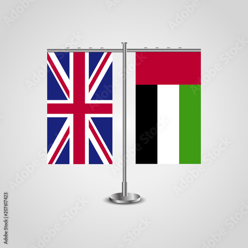 Table stand with flags of United Kingdom and United Arab Emirates.Two flag. Flag pole. Symbolizing the cooperation between the two countries. Table flags