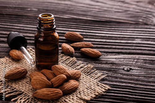 almond essential oil on a wooden background
