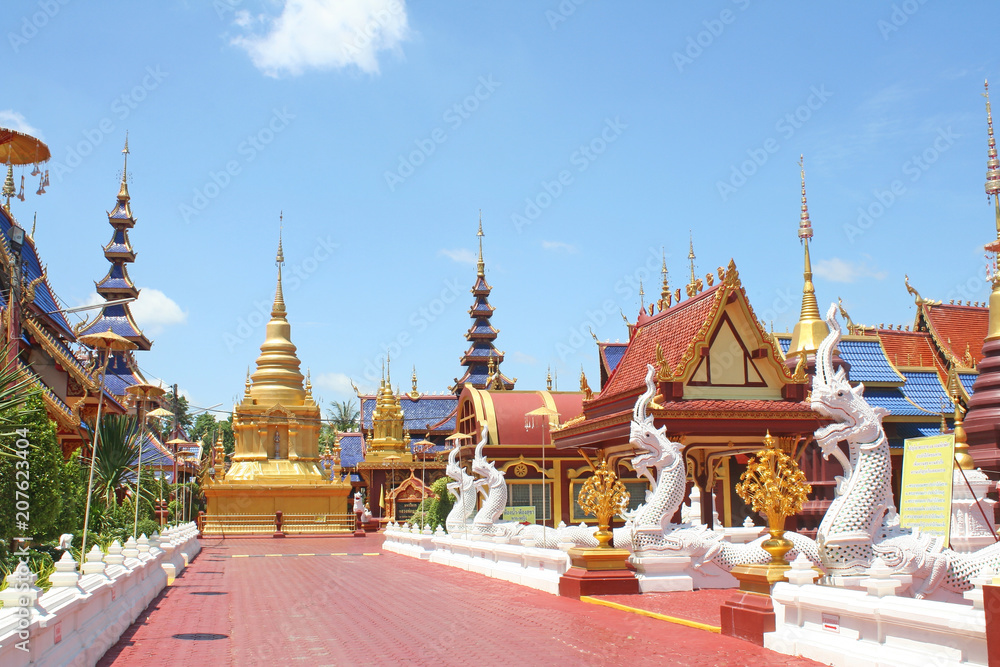 Fototapeta premium Landscape at Phiphat Mongkol Wanaram temple on vivid blue sky in Sukhothai, Thailand