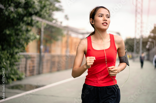 woman running in run lane in city.