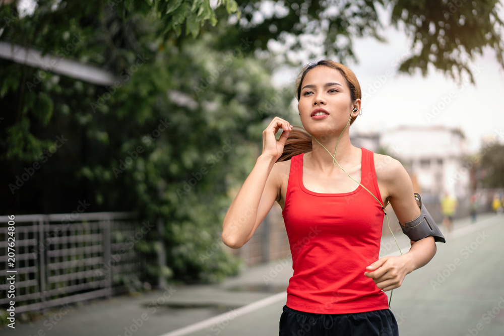 woman running in run lane in city. woman running in run lane in city.