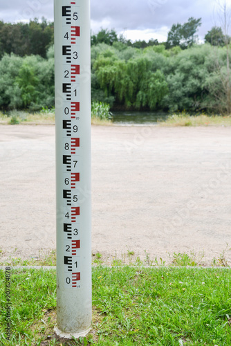 Selective focus of close up water level depth marker measurement tape on edge of river for monitoring and preventing floor distasters. Captured at Zezere River, Constancia, Portugal photo