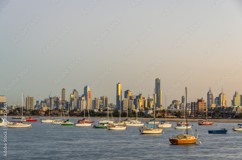 Fototapeta premium Sailing boats moored in St Kilda with the Melbourne skyline in the background.