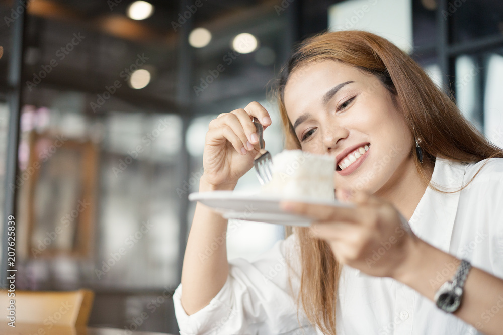 Woman eating cake at dessert cafe. Woman eating cake at dessert cafe.