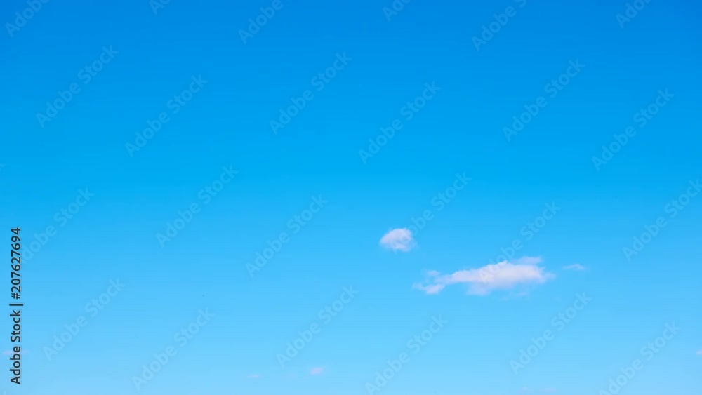 Almost clear blue sky with light white clouds - Seamless loop timelapse 4K Almost clear blue sky with light white clouds - Seamless loop timelapse 4K