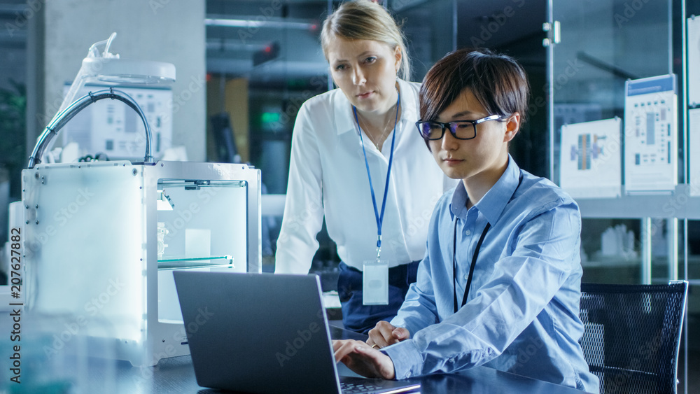 Two Engineers Work with Three Dimensional Printer in Laboratory Two Engineers Work with Three Dimensional Printer in Laboratory