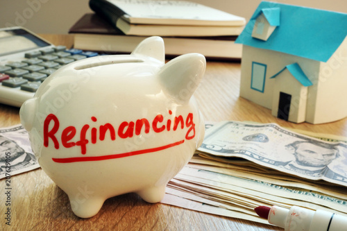Refinancing written on a piggy bank.