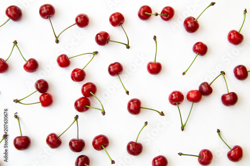 Cherries on white background isolated in chaotic manner as background