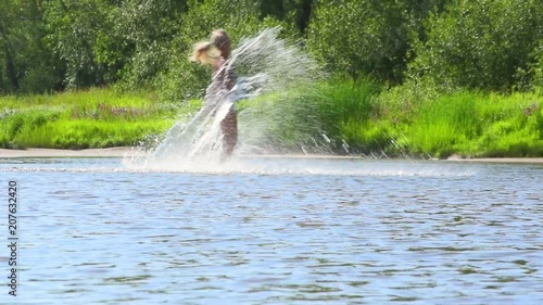  Happy girl in a bikini runs and splashing in water. Slow motion
