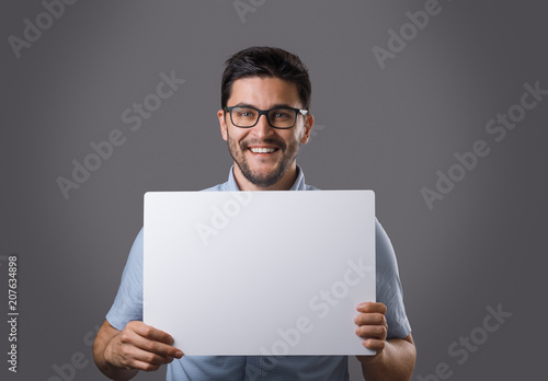 Youn man holds board