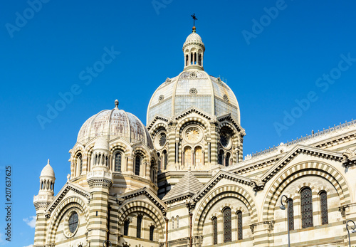 Close-up view of the dome of Sainte-Marie-Majeure cathedral in Marseille, known as La Major, a neo-byzantine style catholic building achieved in 1893, showing several cupolas, chapels and turrets. © olrat