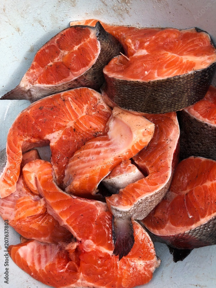 Fresh salmon fish with salt in a white plate Fresh salmon fish with salt in a white plate