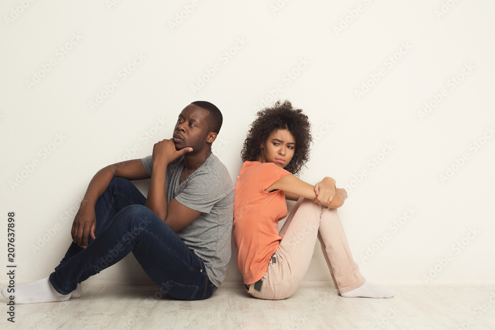 Black couple sitting on floor at new apartment Black couple sitting on floor at new apartment