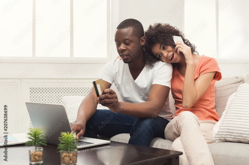 Happy african-american couple shopping online Happy african-american couple shopping online