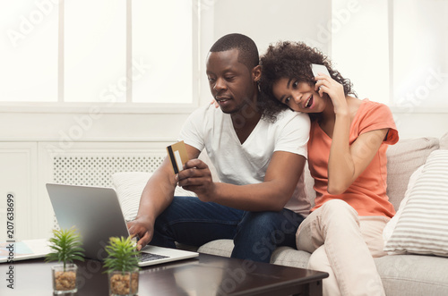 Happy african-american couple shopping online
